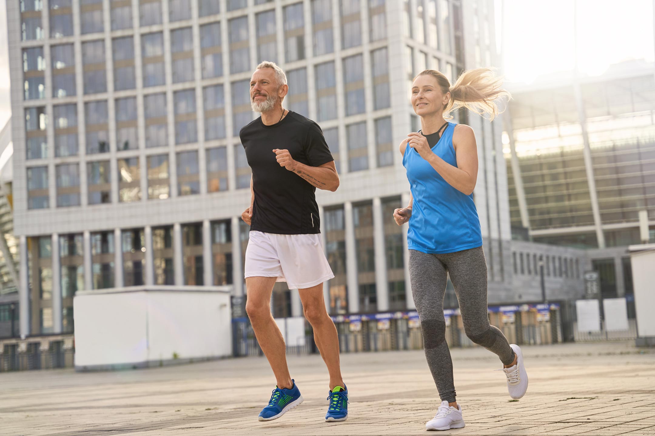 Healthy-fit-couple-jogging-together-in-the-morning Healthy, fit couple jogging together in the morning