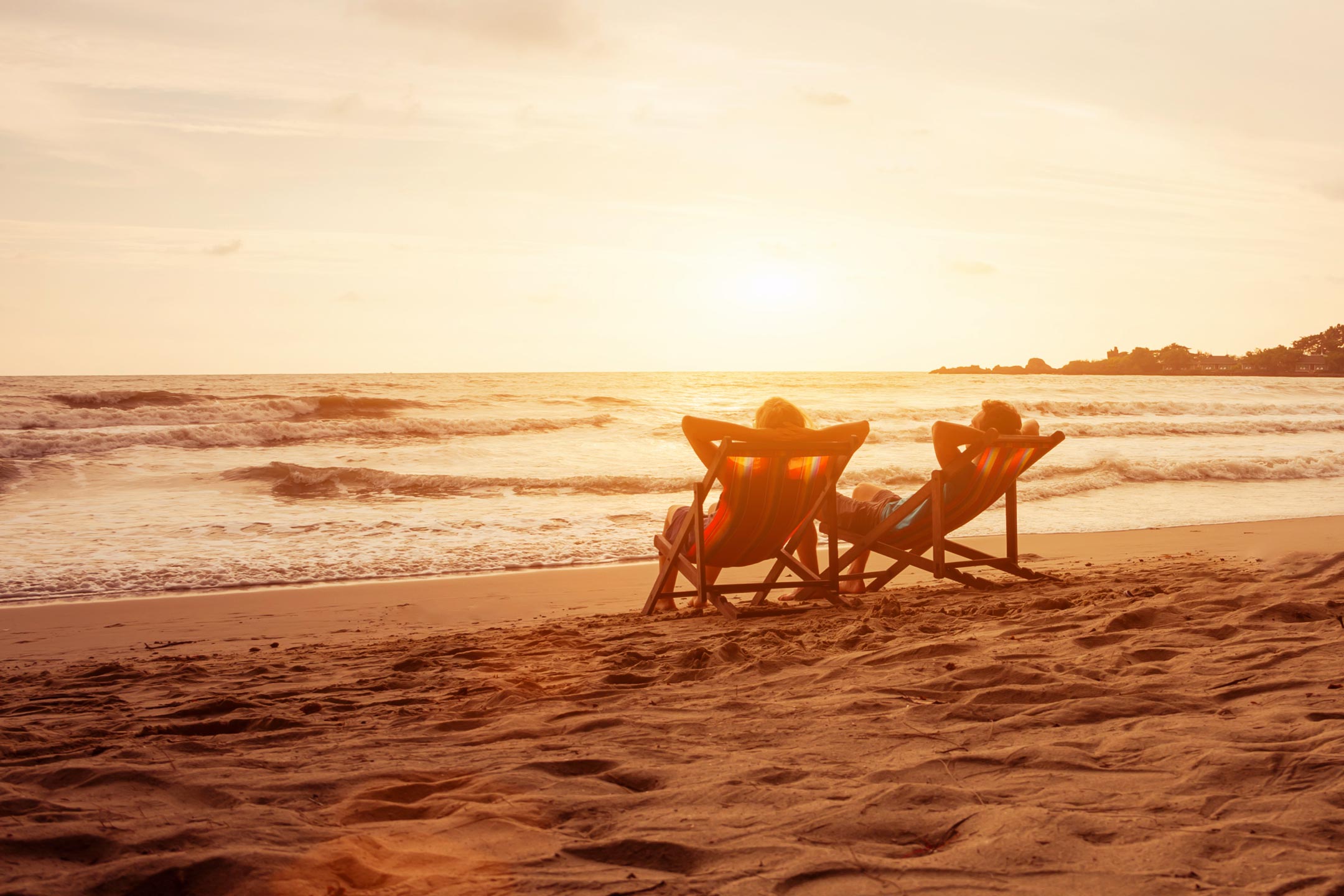Relaxed-couple-enjoying-a-sunset-on-a-luxury-vacation Relaxed couple enjoying a sunset on a luxury vacation